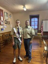 Two people in Class A uniforms.