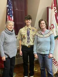 Two woman stand next to Ben, who is in the middle.