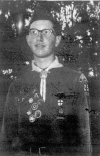 A black and white newspaper photo of a boy wearing the class A uniform.  He is wearing glasses, and 253 is visible on his left arm.