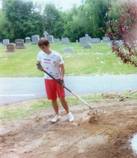 Brett raking to the left of the tree.