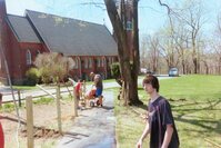 Seth's dad pouring cement into a hole with another scout.  Ian is off to the right, giving the camera a dirty look.