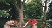 Two scouts taking a drink from water fountains.