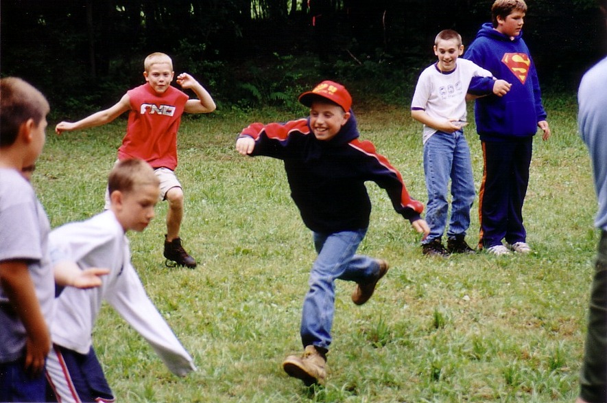 Three scouts are running towards something, while two scouts off to the right watch.