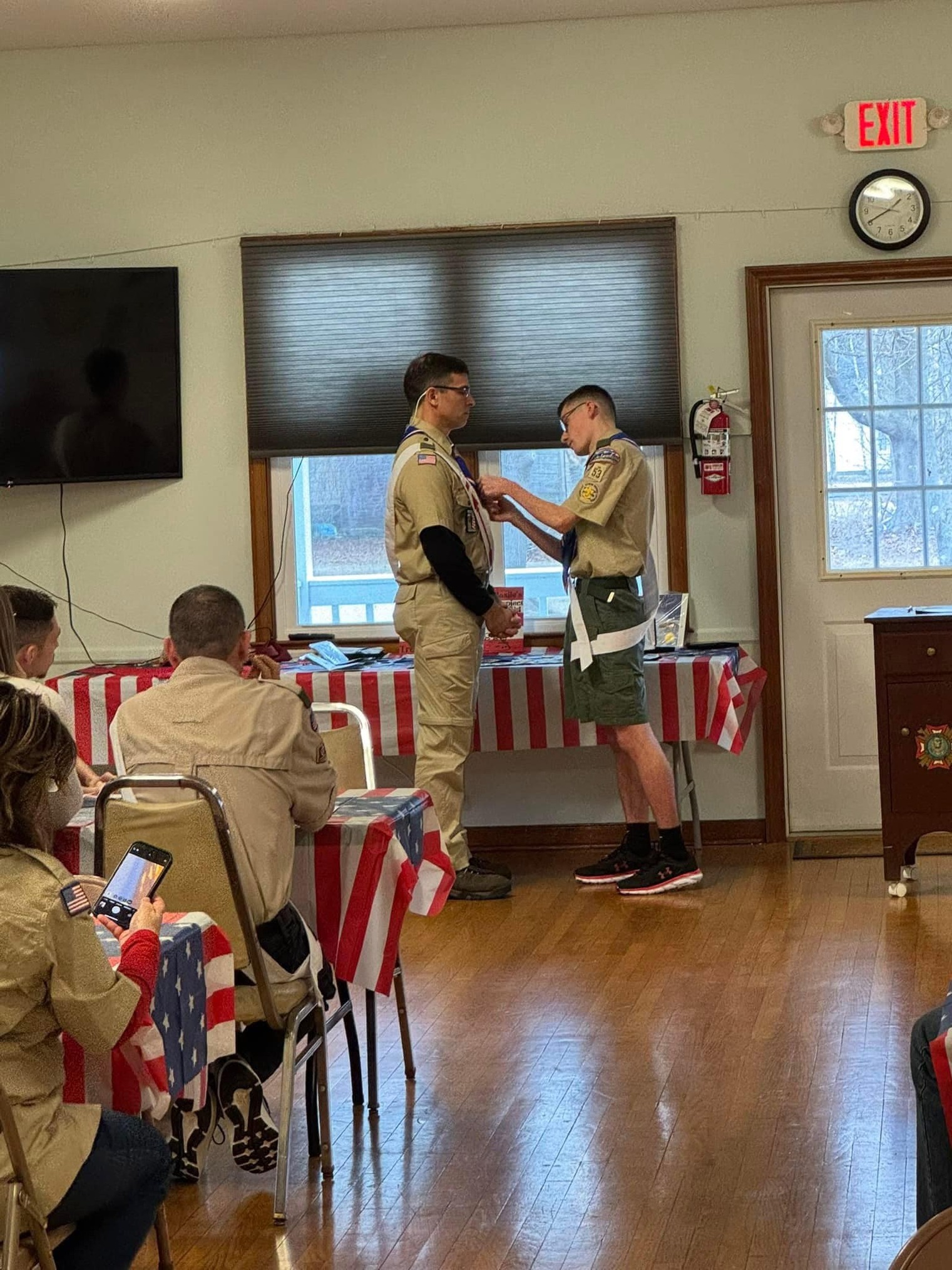Anthony putting a pin on Scoutmaster Brewer's class A uniform