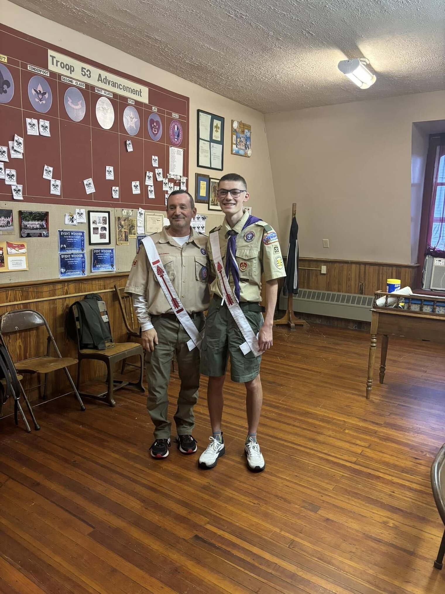 Two people in Class A uniforms.
