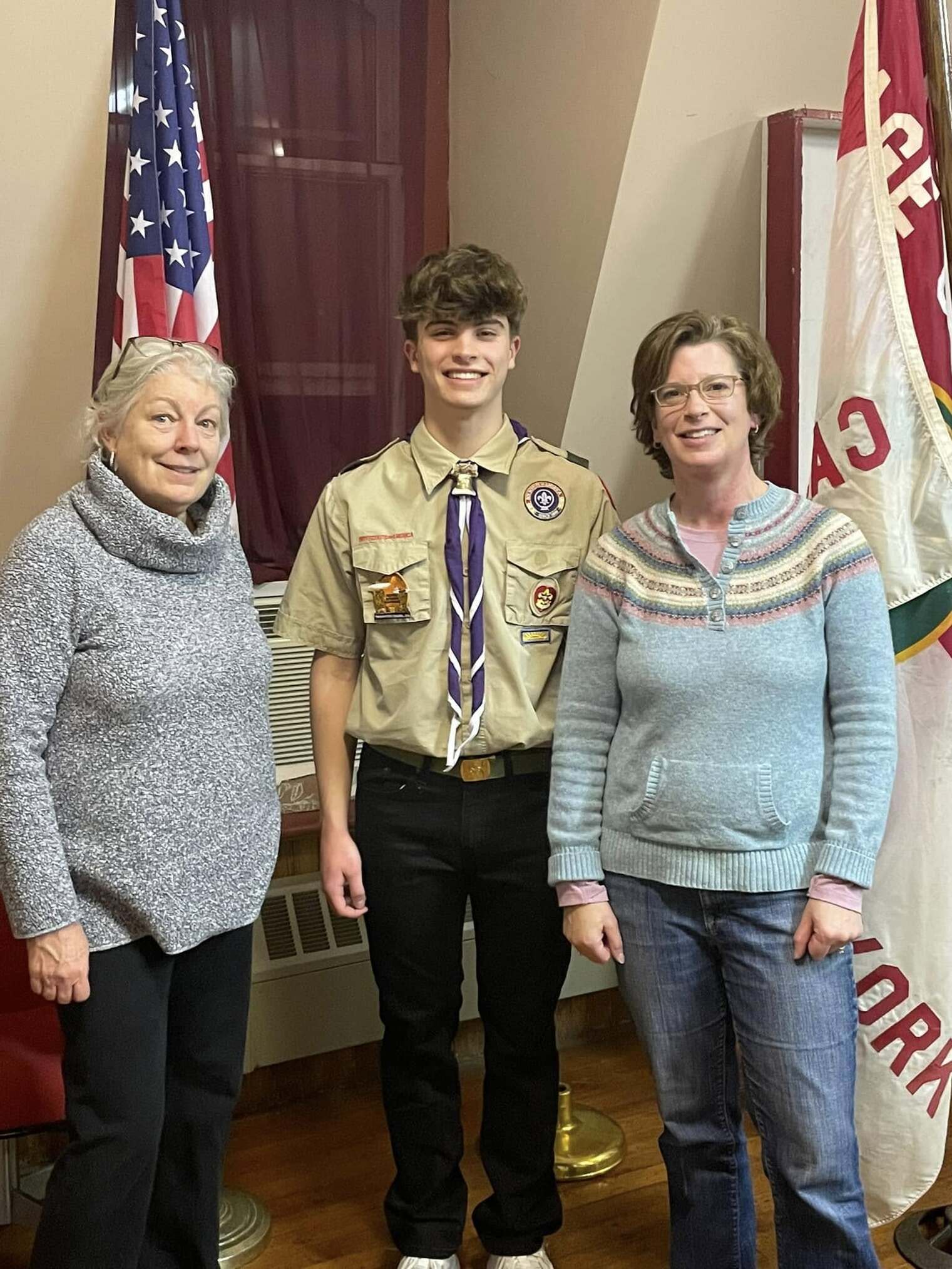 Two woman stand next to Ben, who is in the middle.