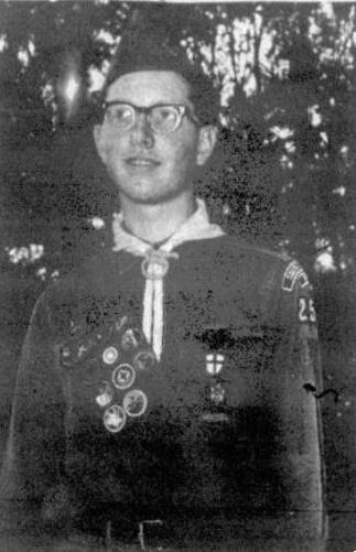 A black and white newspaper photo of a boy wearing the class A uniform.  He is wearing glasses, and 253 is visible on his left arm.