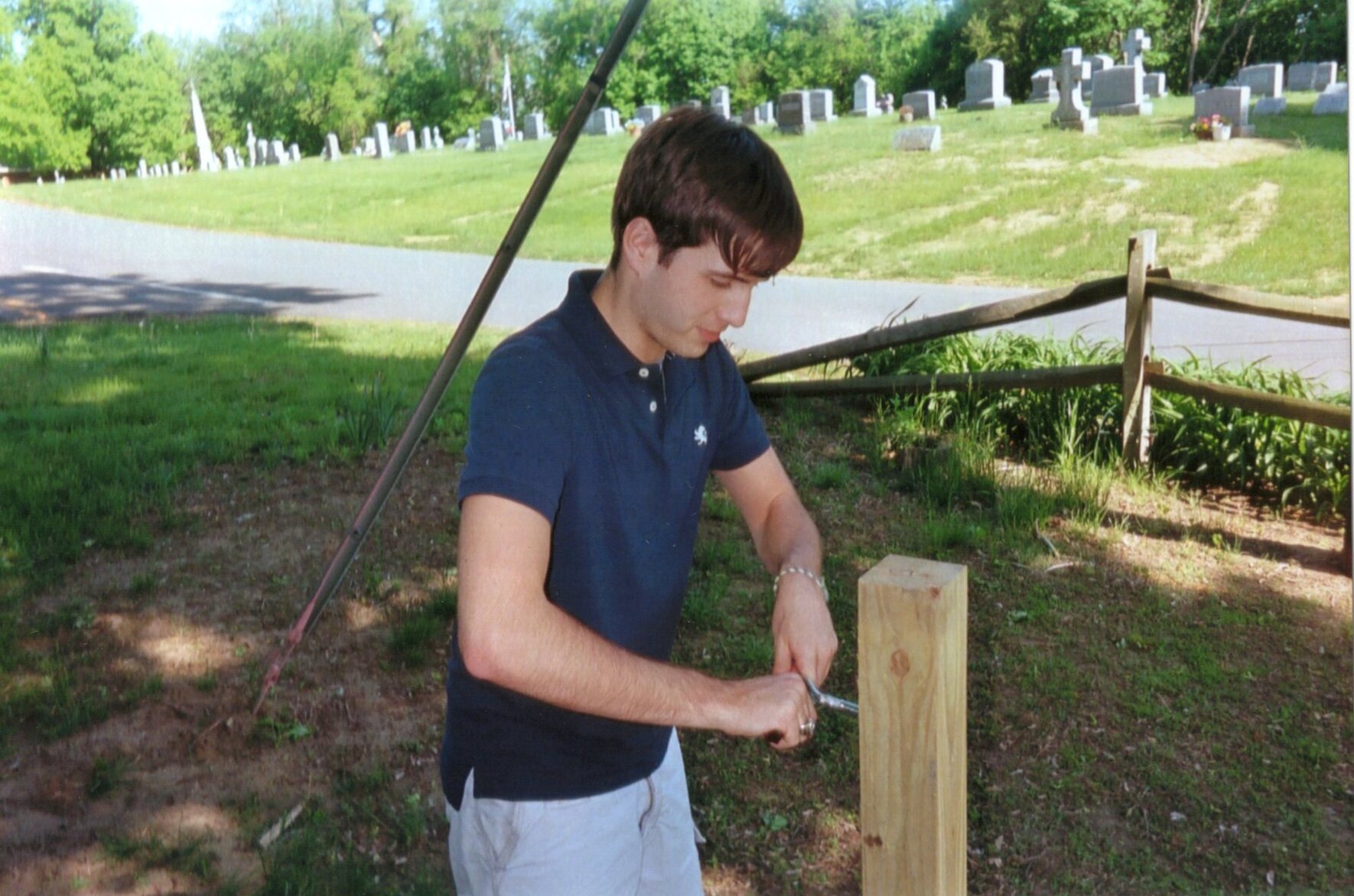 Brett twisting an eye-hook into a post.