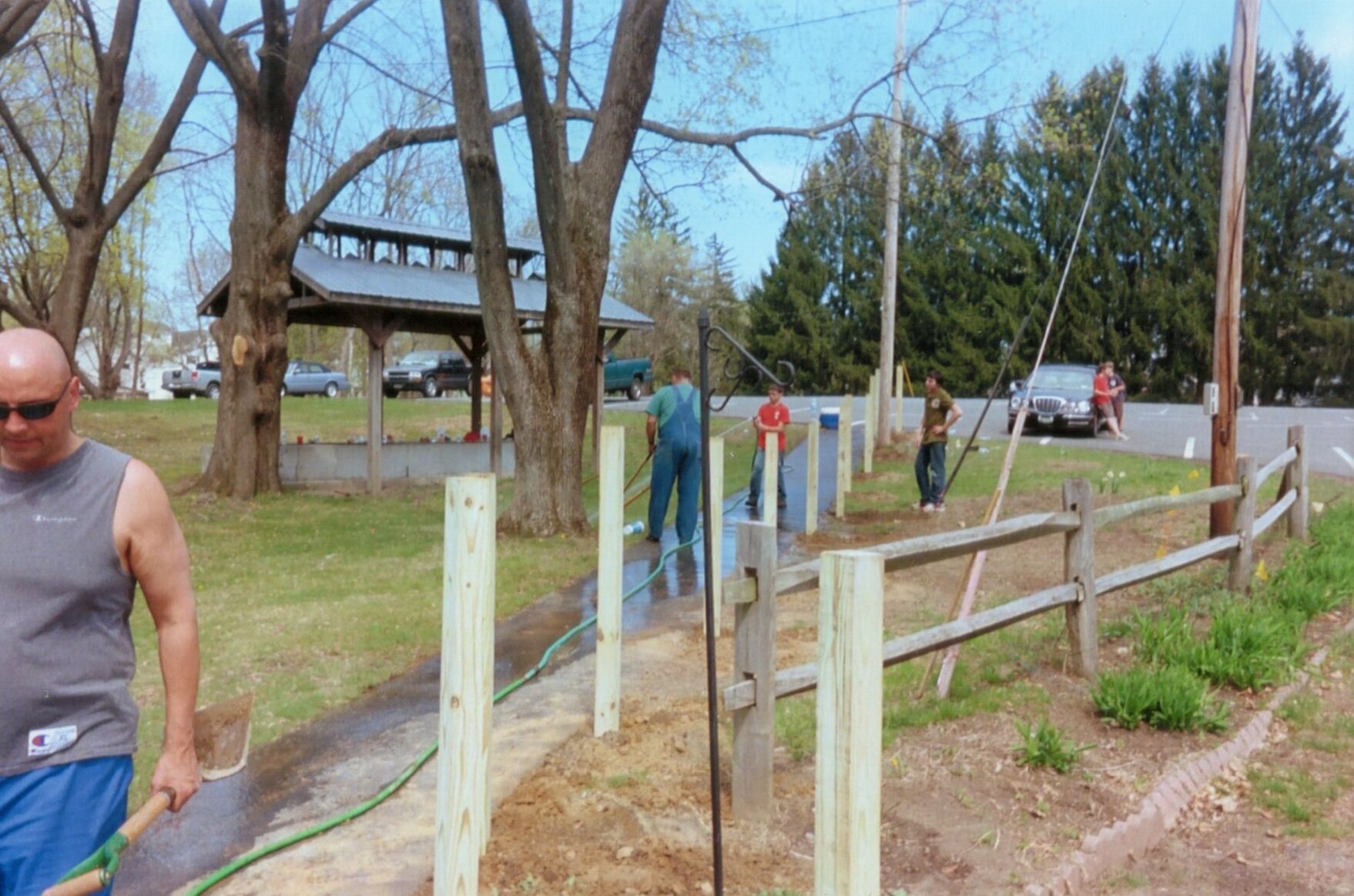 Seth's dad is on the left, walking with a shovel.  Scout Master Rich Noll is holding a shovel, and Will is spraying it with a hose.  Nate is to the right standing.  Two scouts are leaning against my car in the background.